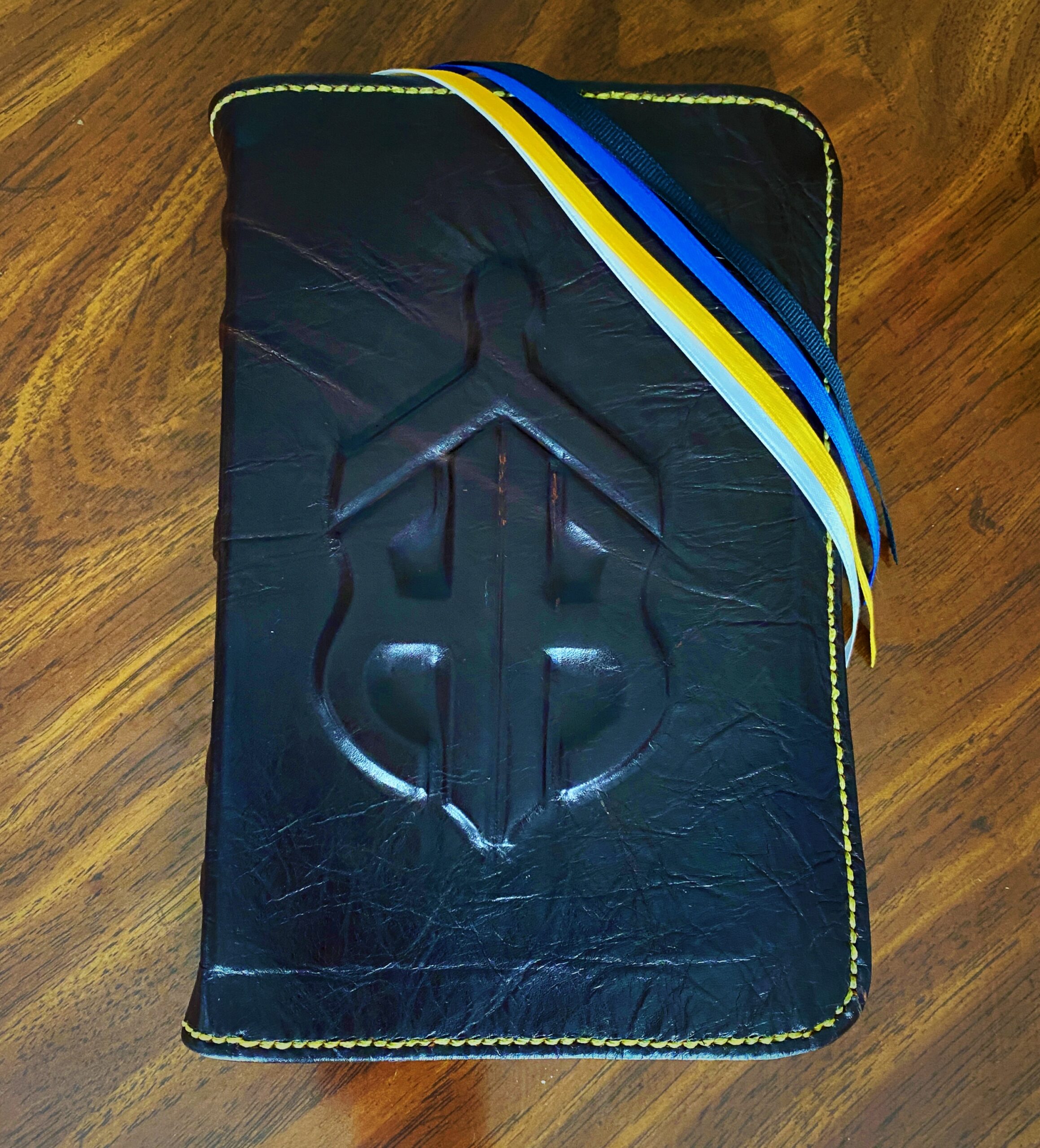 Bailey's first Bible rebind in navy leather with blue and yellow ribbons