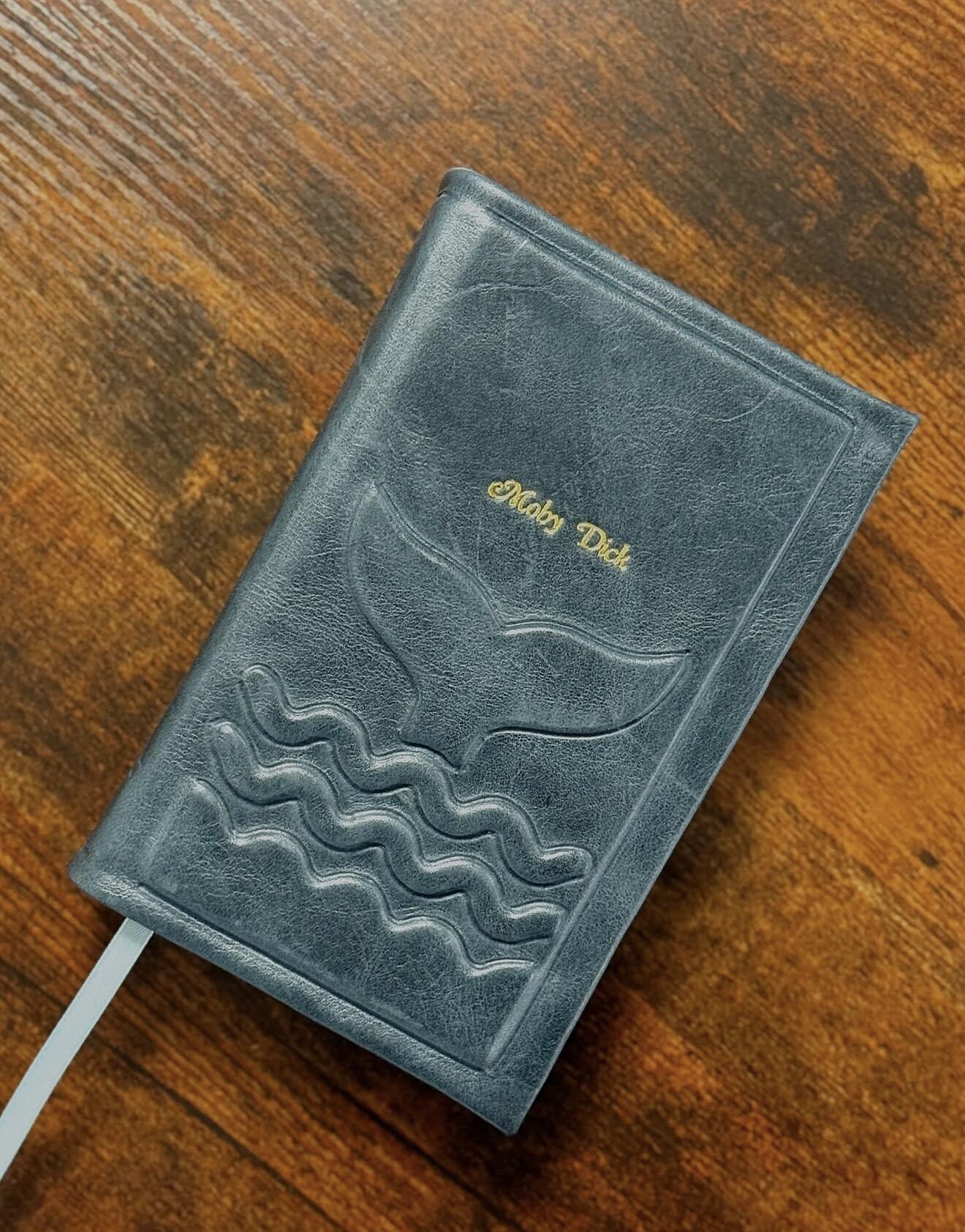 Blue-grey leather Bible rebind stamped with waves and a whale tail