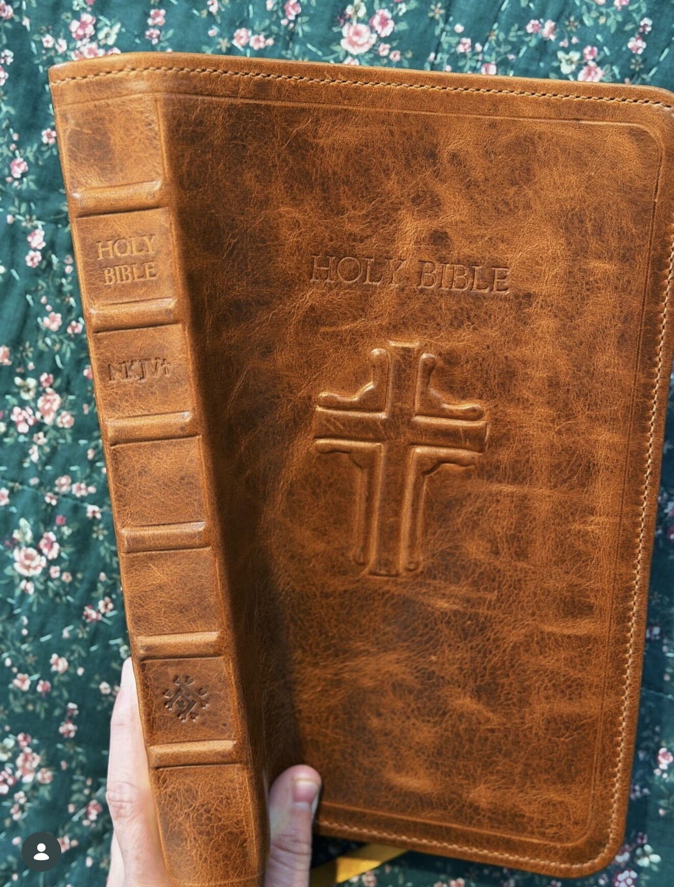Cognac leather Bible rebind with raised spine bands and a stamped cross