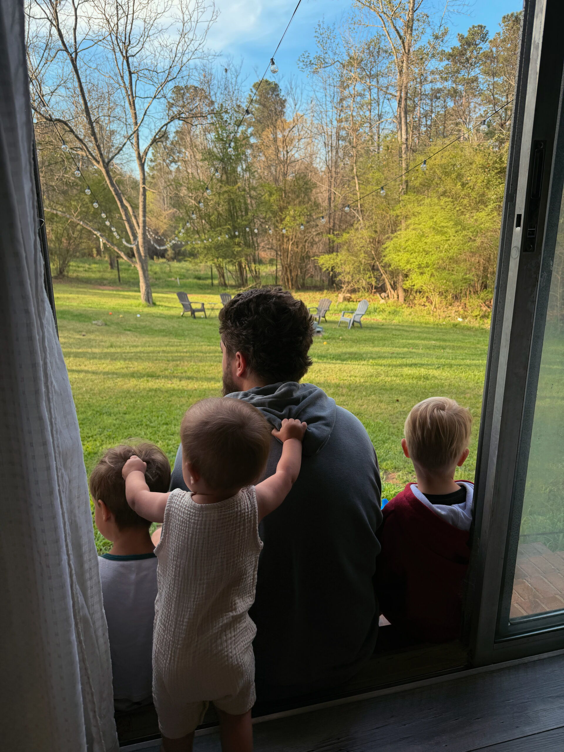 Bailey Miller and his kids looking out at the yard